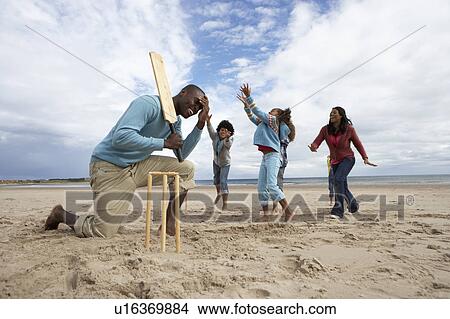 Family playing cricket on beach View Large Photo Image Picture - Family playing cricket on beach. Fotosearch