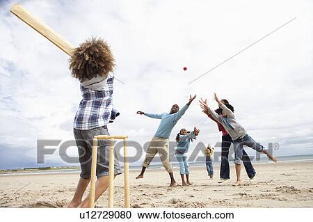 Family playing cricket on beach View Large Photo Image Stock Image - Family playing cricket on beach. Fotosearch