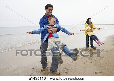 Family playing on beach View Large Photo Image Picture - Family playing on beach. Fotosearch