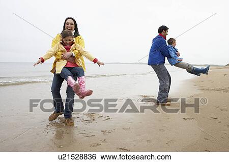 Family playing on beach View Large Photo Image Stock Photograph - Family playing on beach. Fotosearch