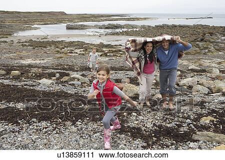 Family walking on beach View Large Photo Image Stock Image - Family walking on beach. Fotosearch