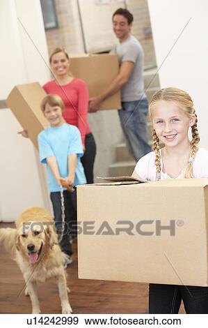 Family with dog on moving day carrying cardboard boxes View Large Photo Image Stock Photo - Family with dog on moving day carrying cardboard boxes. Fotosearch