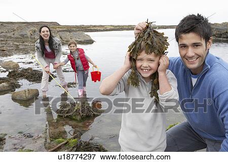 Stock Photo - Family with seaweed. Fotosearch