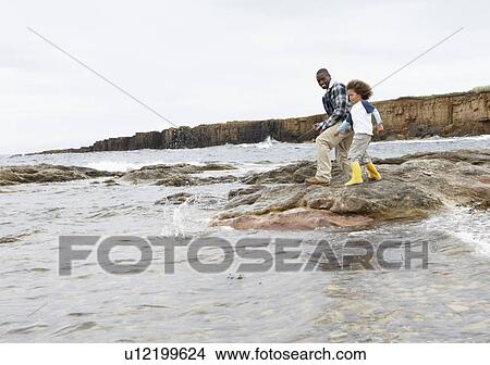 Picture - Father and son on beach. Fotosearch