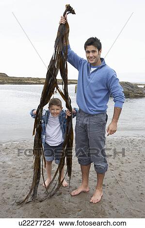 Father and son on beach View Large Photo Image Picture - Father and son on beach. Fotosearch