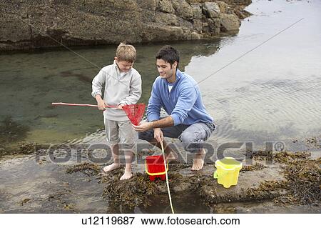 Father and son on beach View Large Photo Image Stock Photo - Father and son on beach. Fotosearch