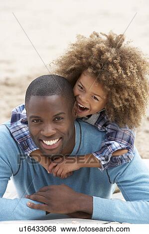 Father and son playing piggyback on beach View Large Photo Image Stock Photo - Father and son playing piggyback on beach. Fotosearch