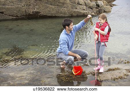 Father with daughter on beach View Large Photo Image Stock Image - Father with daughter on beach. Fotosearch