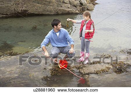Father with daughter on beach View Large Photo Image Stock Image - Father with daughter on beach. Fotosearch