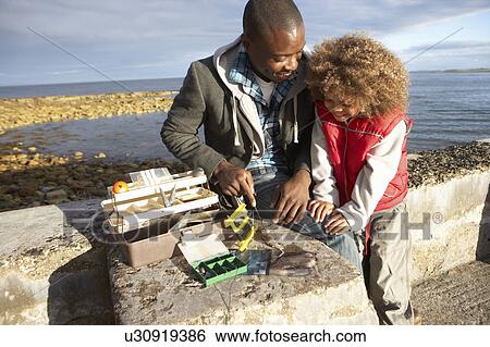 Father with son fishing View Large Photo Image Stock Photograph - Father with son fishing. Fotosearch