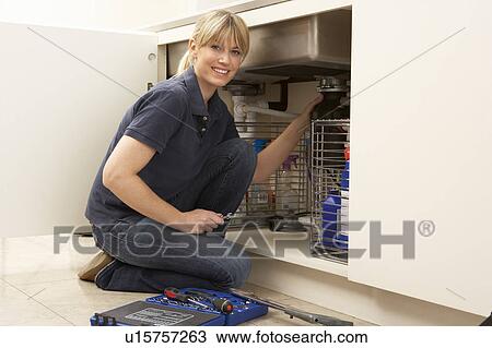 Female Plumber Working On Sink In Kitchen View Large Photo Image Stock Image - Female Plumber Working On Sink In Kitchen. Fotosearch
