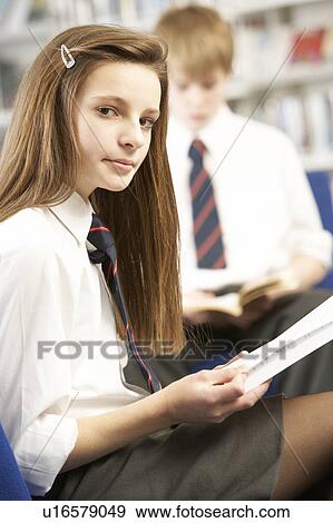 Female Teenage Student In Library Reading Book View Large Photo Image Stock Photo - Female Teenage Student In Library Reading Book. Fotosearch