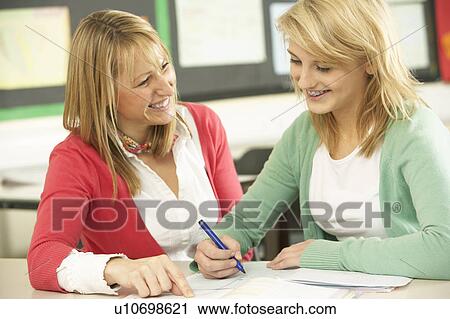 Female Teenage Student Studying In Classroom With Teacher View Large Photo Image Stock Image - Female Teenage Student Studying In Classroom With Teacher. Fotosearch