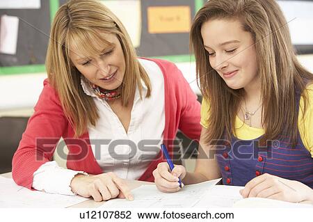 Female Teenage Student Studying In Classroom With Teacher View Large Photo Image Stock Image - Female Teenage Student Studying In Classroom With Teacher. Fotosearch