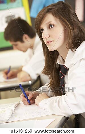 Stock Photo - Female Teenage Student Studying In Classroom. Fotosearch