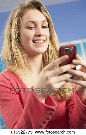 Female Teenage Student Using Mobile Phone By Lockers In School View Large Photo Image Stock Photography - Female Teenage Student Using Mobile Phone By Lockers In School. Fotosearch