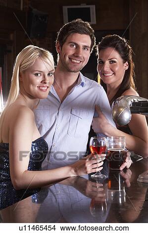 Friends having a drink in bar View Large Photo Image Picture - Friends having a drink in bar. Fotosearch