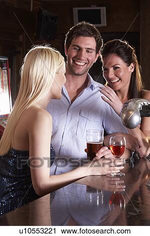 Friends laughing at bar View Large Photo Image Stock Image - Friends laughing at bar. Fotosearch