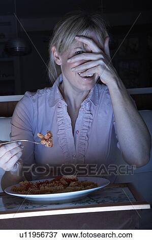 Frightened Woman Enjoying Meal Whilst Watching TV View Large Photo Image Stock Photo - Frightened Woman Enjoying Meal Whilst Watching TV. Fotosearch