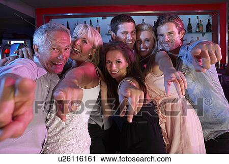 Stock Image - Group Of People Having Fun In Busy Bar. Fotosearch
