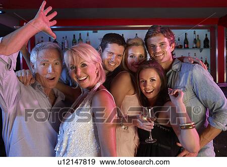 Stock Photo - Group Of People Having Fun In Busy Bar. Fotosearch