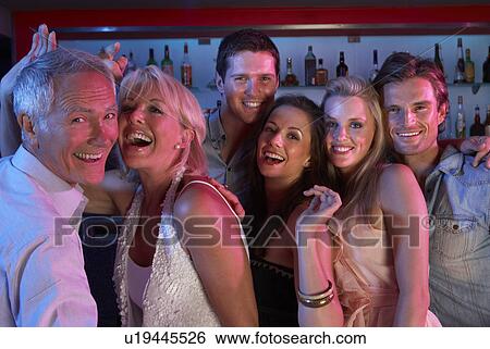 Group Of People Having Fun In Busy Bar View Large Photo Image Stock Photograph - Group Of People Having Fun In Busy Bar. Fotosearch