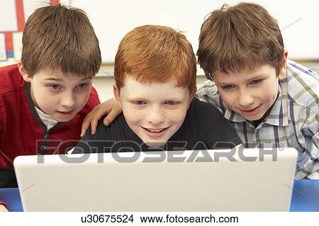 Picture - Group Of Schoolboys In IT Class Using Computer. Fotosearch