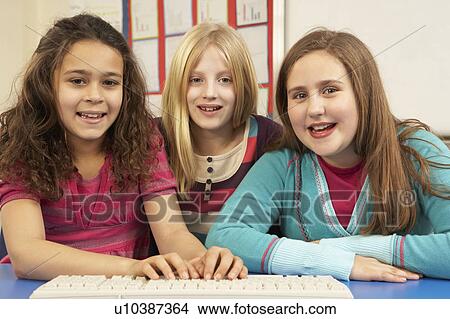 Picture - Group Of Schoolgirls In IT Class Using Computer. Fotosearch