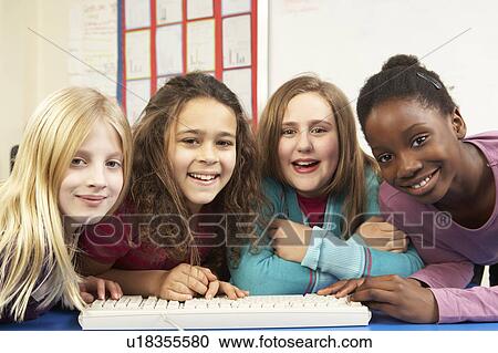 Stock Image - Group Of Schoolgirls In IT Class Using Computer. Fotosearch