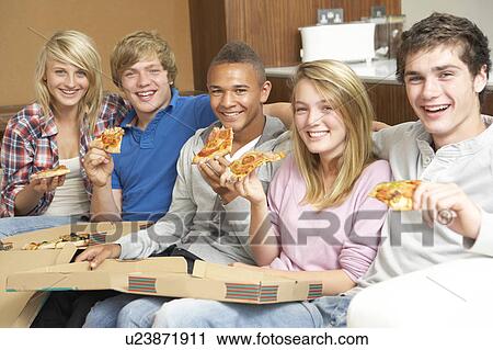 Group Of Teenage Friends Sitting On Sofa At Home Eating Pizza View Large Photo Image Stock Image - Group Of Teenage Friends Sitting On Sofa At Home Eating Pizza. Fotosearch