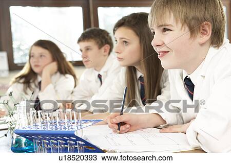 Stock Image - Group Of Teenage Students In Science Class. Fotosearch
