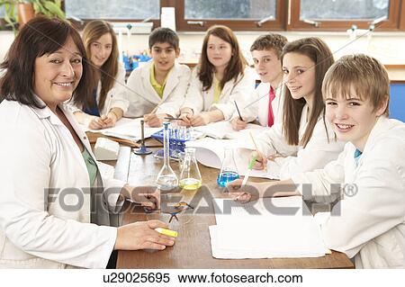 Stock Photography - Group Of Teenage Students In Science Class With Tutor. Fotosearch
