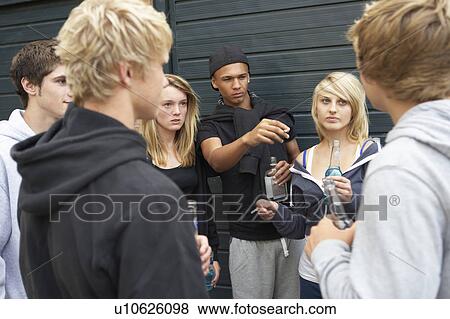 Group Of Threatening Teenagers Hanging Out Together Outside Drin View Large Photo Image Stock Photo - Group Of Threatening Teenagers Hanging Out Together Outside Drin. Fotosearch