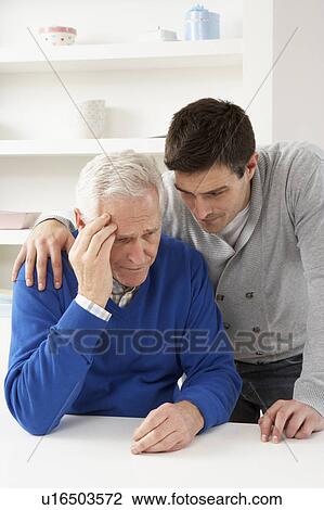 Stock Image - Grown Up Son Consoling Senior Parent. Fotosearch