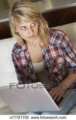 Guilty Looking Teenage Girl Using Laptop At Home View Large Photo Image Stock Image - Guilty Looking Teenage Girl Using Laptop At Home. Fotosearch