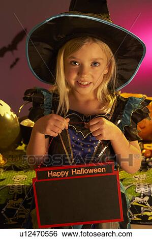 Stock Photograph - Halloween party with a child holding sign. Fotosearch