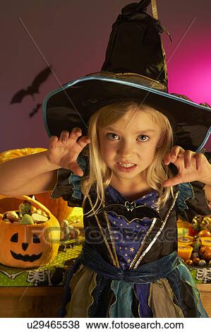 Stock Photo - Halloween party with a child wearing scaring costume. Fotosearch