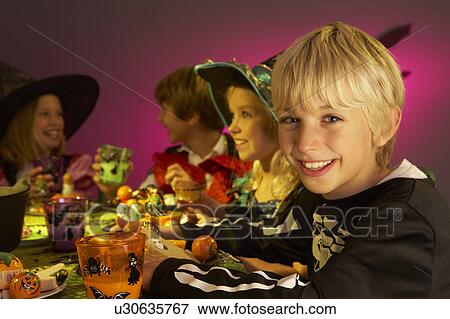 Halloween party with children having fun in fancy costumes View Large Photo Image Stock Photo - Halloween party with children having fun in fancy costumes. Fotosearch