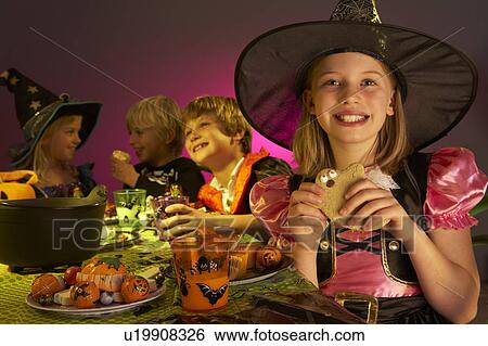 Stock Photograph - Halloween party with children having fun in fancy costumes. Fotosearch