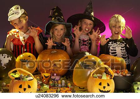 Stock Photograph - Halloween party with children wearing fancy costumes. Fotosearch