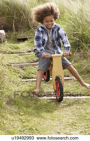 Happy boy riding a bike View Large Photo Image Stock Image - Happy boy riding a bike. Fotosearch