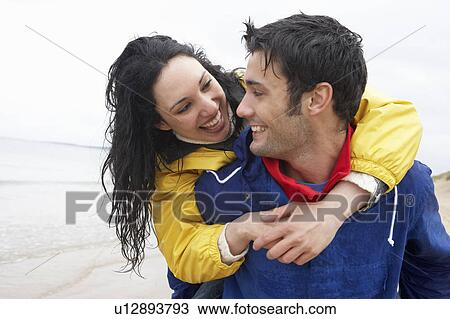 Stock Image - Happy couple on beach in love. Fotosearch