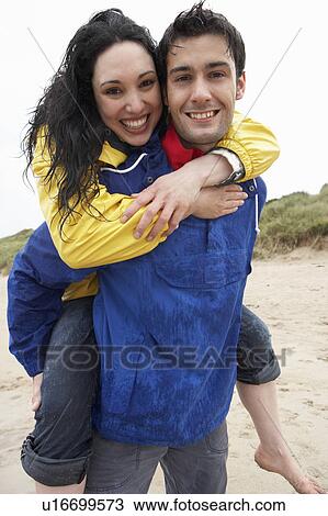 Stock Image - Happy couple on beach in love. Fotosearch