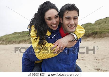 Happy couple on beach in love View Large Photo Image Stock Image - Happy couple on beach in love. Fotosearch