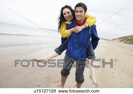 Happy couple on beach in love View Large Photo Image Stock Photo - Happy couple on beach in love. Fotosearch