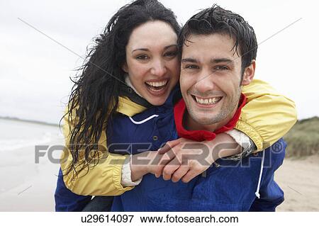 Happy couple on beach in love View Large Photo Image Stock Photo - Happy couple on beach in love. Fotosearch
