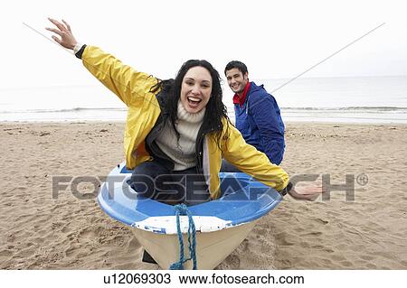 Stock Image - Happy couple on beach. Fotosearch
