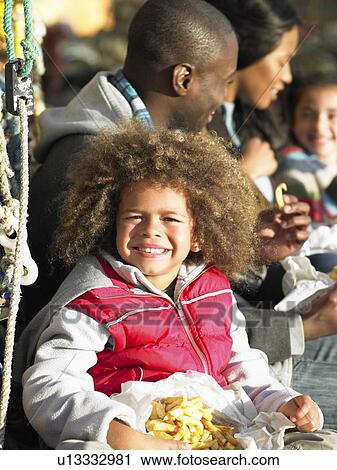 Stock Image - Happy family having picnic. Fotosearch
