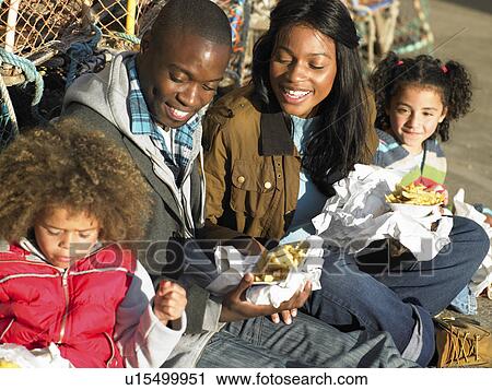 Stock Image - Happy family having picnic. Fotosearch