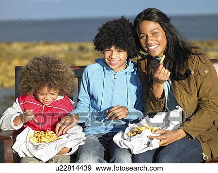 Stock Photo - Happy family having picnic. Fotosearch